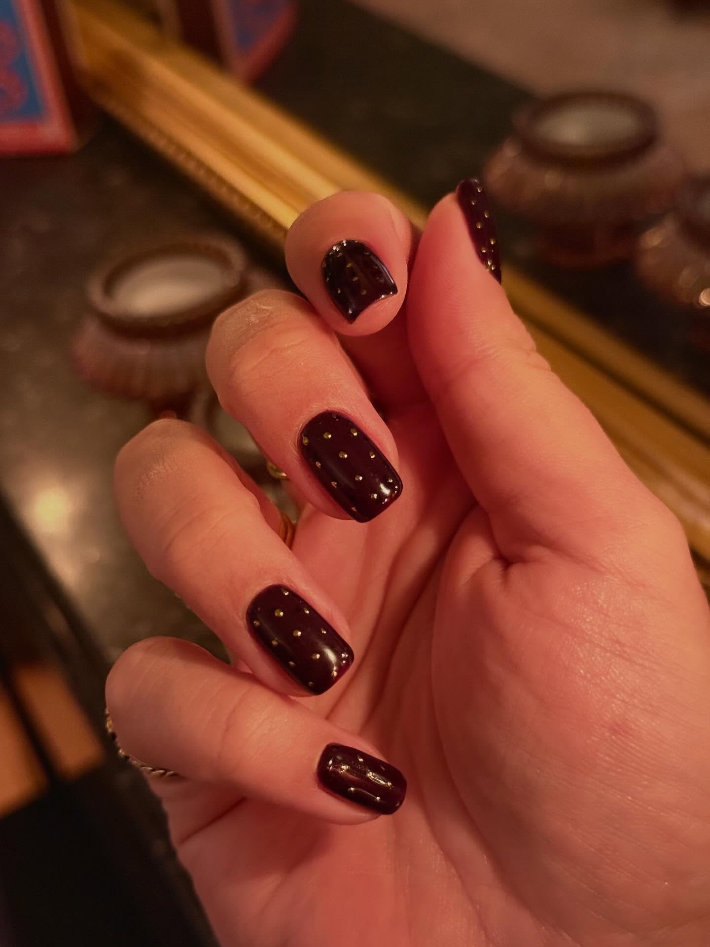 Dark nails with gold studs